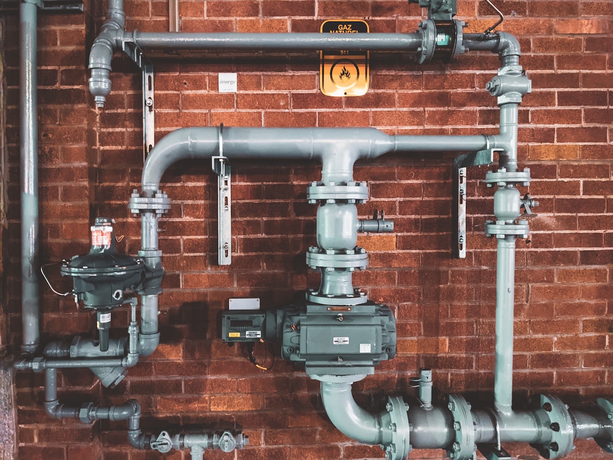 Gas installation and pipe assembly on a brick wall — the infrastructure HVAC businesses maintain daily